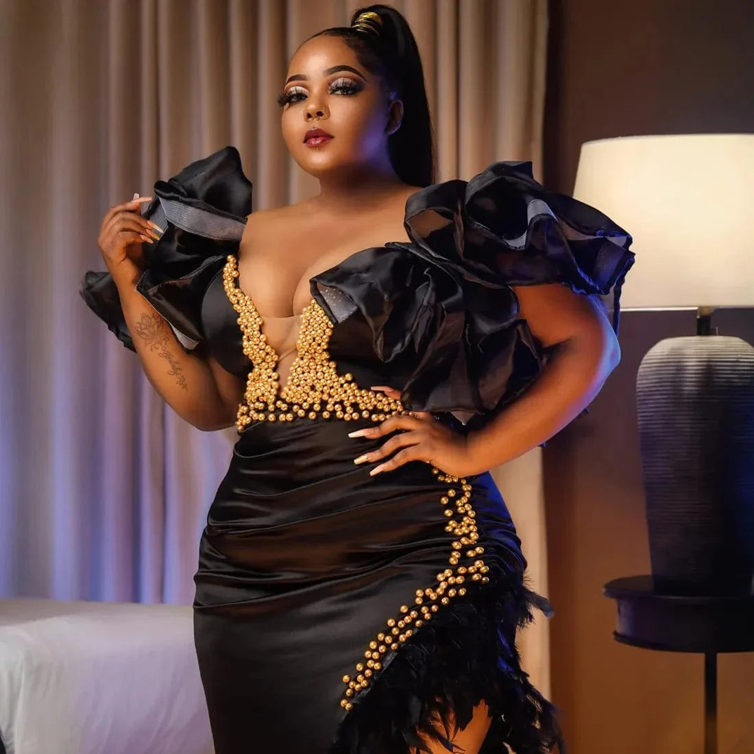 Black V-neck mermaid prom dress by SHOWLU FASHION STORE with feather and pearl embellishments, perfect for elegant evening events.