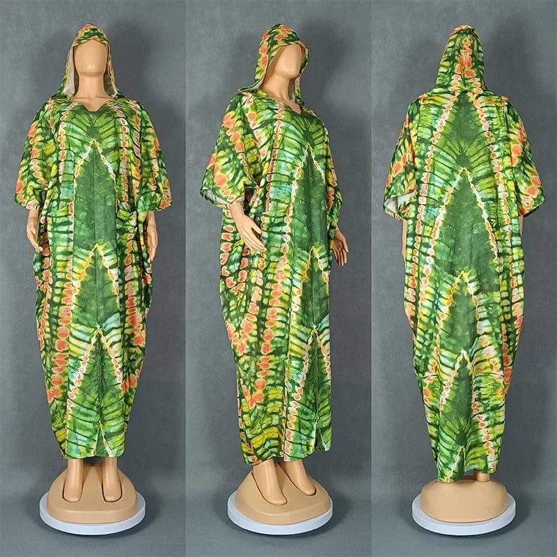 A green and orange tie-dye hooded kaftan dress with a loose, flowing silhouette.