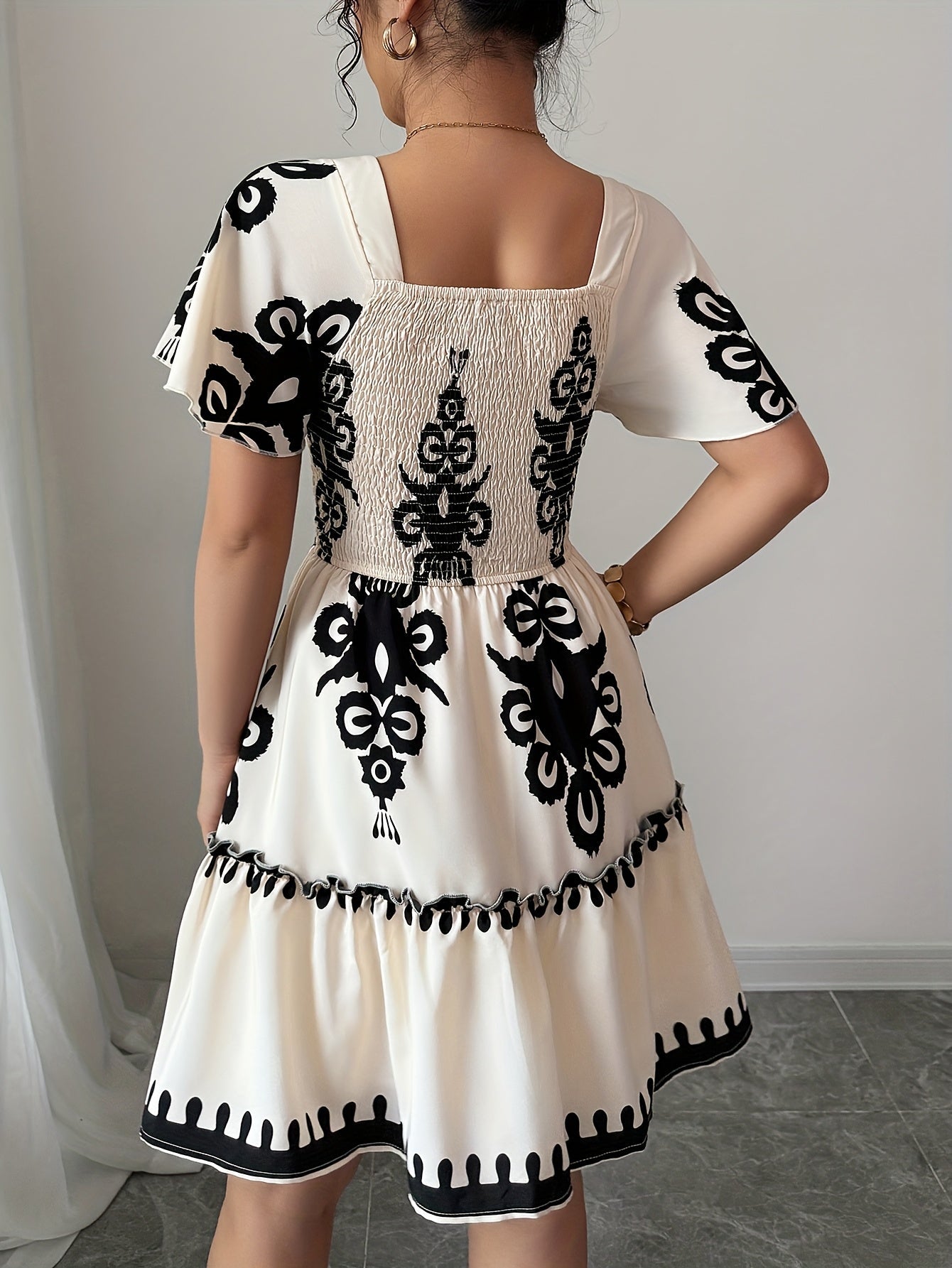 SHOWLU FASHION square neck mini dress with printed A-line pleated design, featuring a stylish and feminine silhouette.