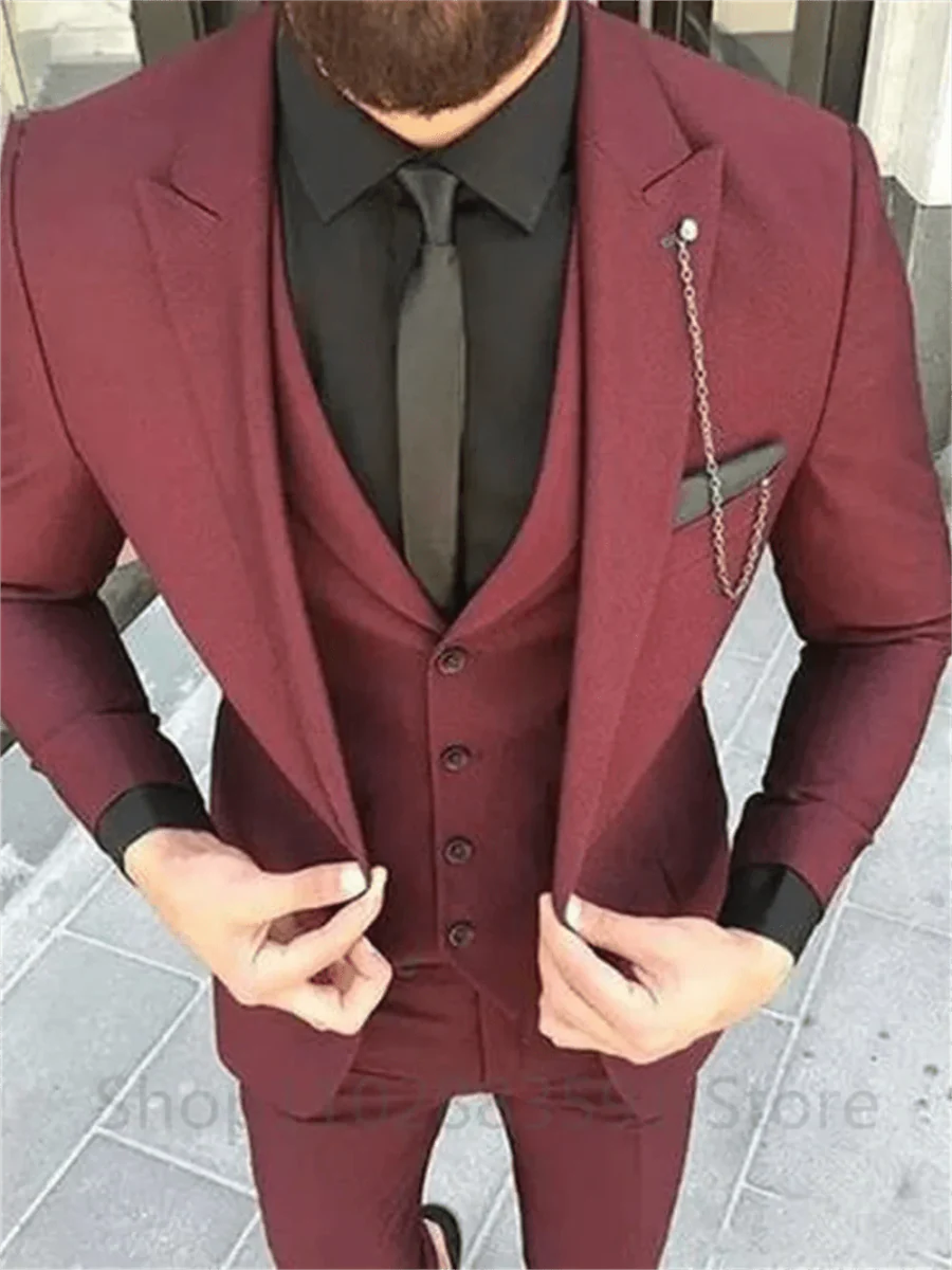 Men's burgundy 3-piece slim fit suit with peak lapel, jacket, vest, and pants, suitable for formal events and weddings.