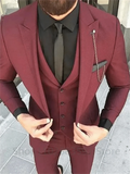Men's burgundy slim fit suit by Showlu Fashion, featuring a wool peak lapel tuxedo jacket, vest, and matching pants for formal occasions.