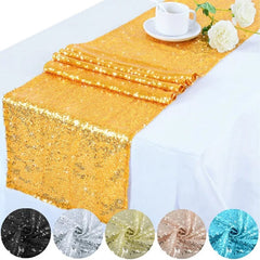 A gold sequin table runner draped over a white tablecloth with color swatches shown below.