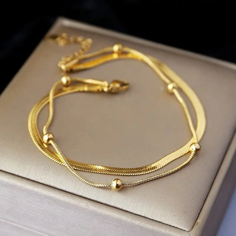 Gold stainless steel double-layer anklet for women, waterproof leg chain with trendy design and adjustable fit.