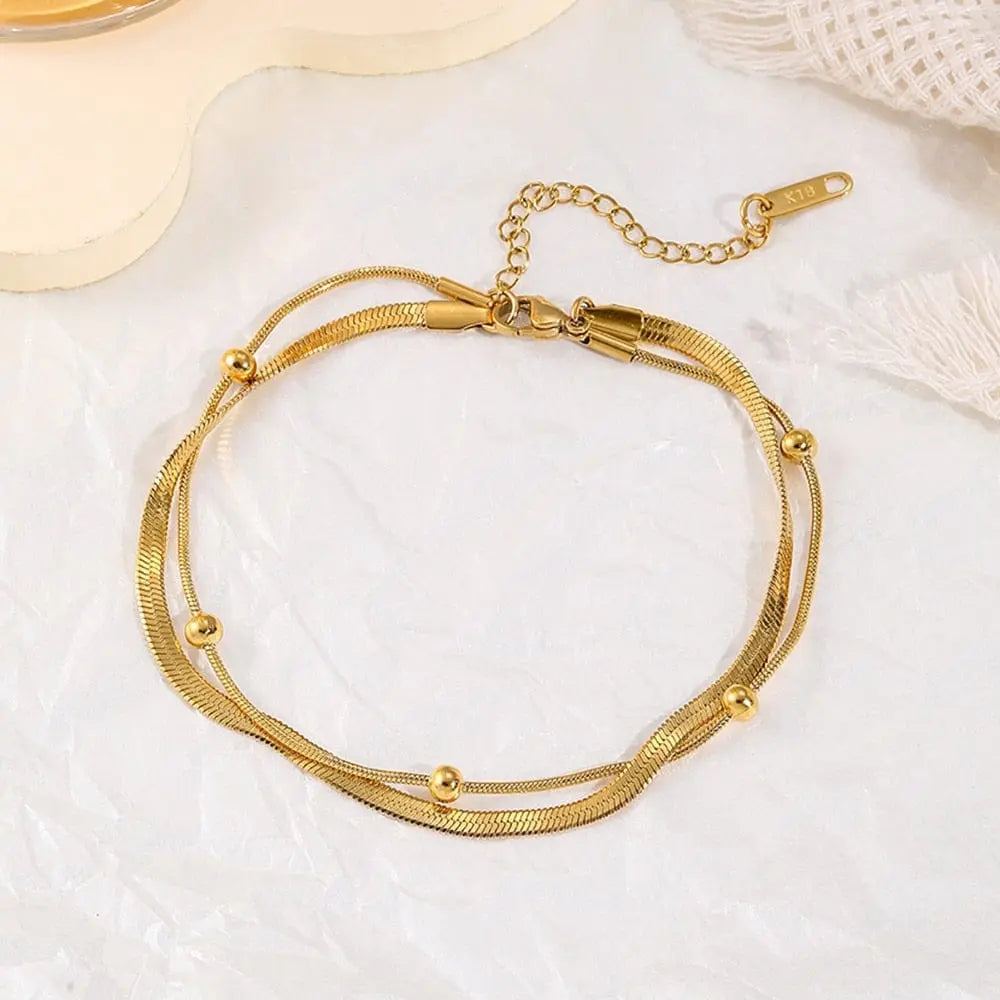 Gold stainless steel double-layer anklet for women, waterproof leg chain with trendy design and jewelry style.