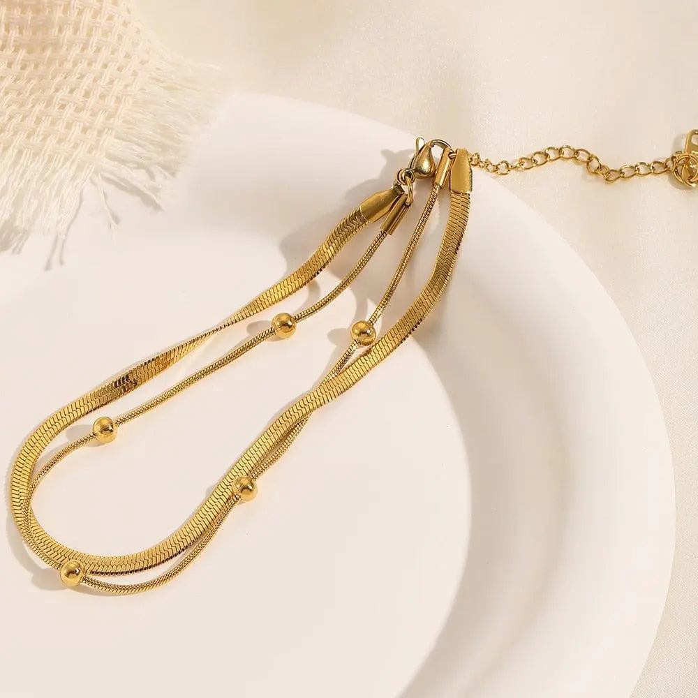 Gold stainless steel double-layer anklet for women, waterproof leg chain with trendy design and adjustable fit.