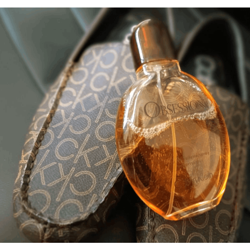 Calvin Klein Obsession for Men Oriental Woody EDT spray, bottle with black cap and gold accents, displayed on a plain background.