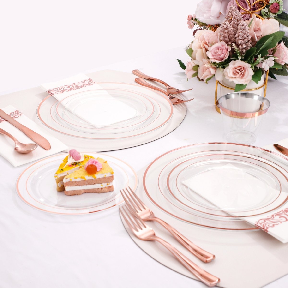 DaYammi 350-piece rose gold plastic dinnerware set with plates, cups, cutlery, and napkins for stylish parties and gatherings.