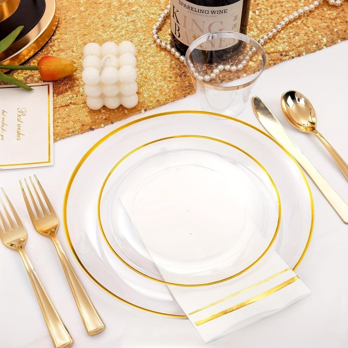 Showlu Fashion Store gold plastic cutlery and dinnerware set with plates, cups, napkins, and utensils for 50 guests.