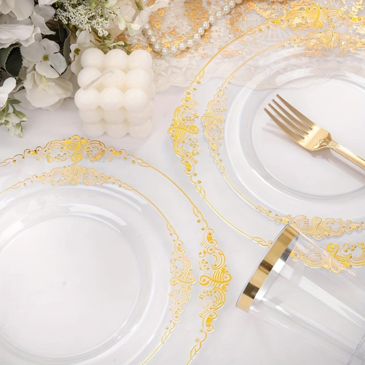 Nervure 350pc gold plastic dinnerware set with disposable plates, cups, silverware, and napkins for 50 guests, perfect for events.
