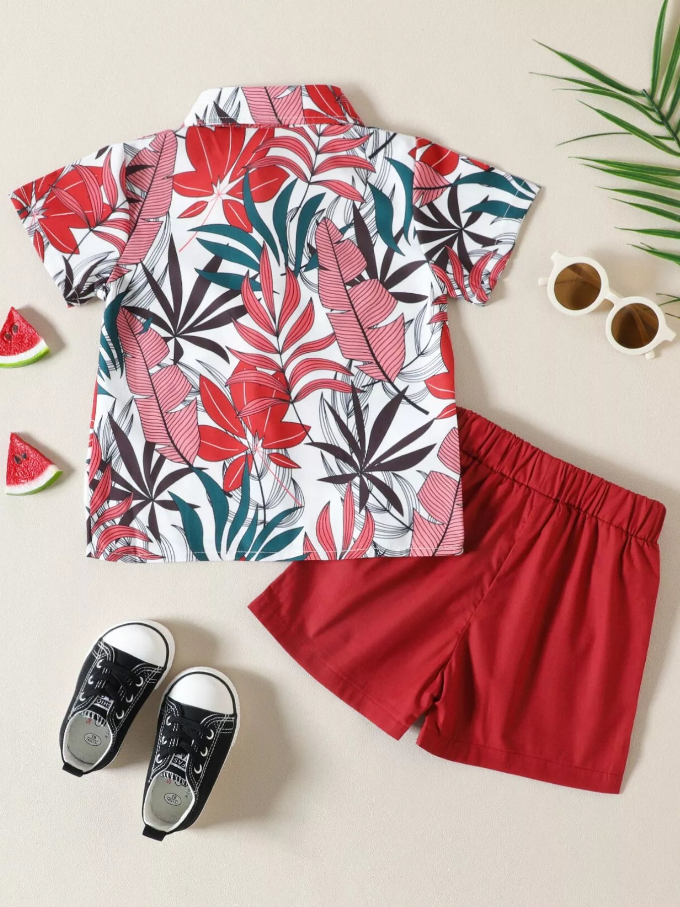 Children's tropical leaf print shirt and shorts set by Trendsi, featuring vibrant green leaves on lightweight fabric.