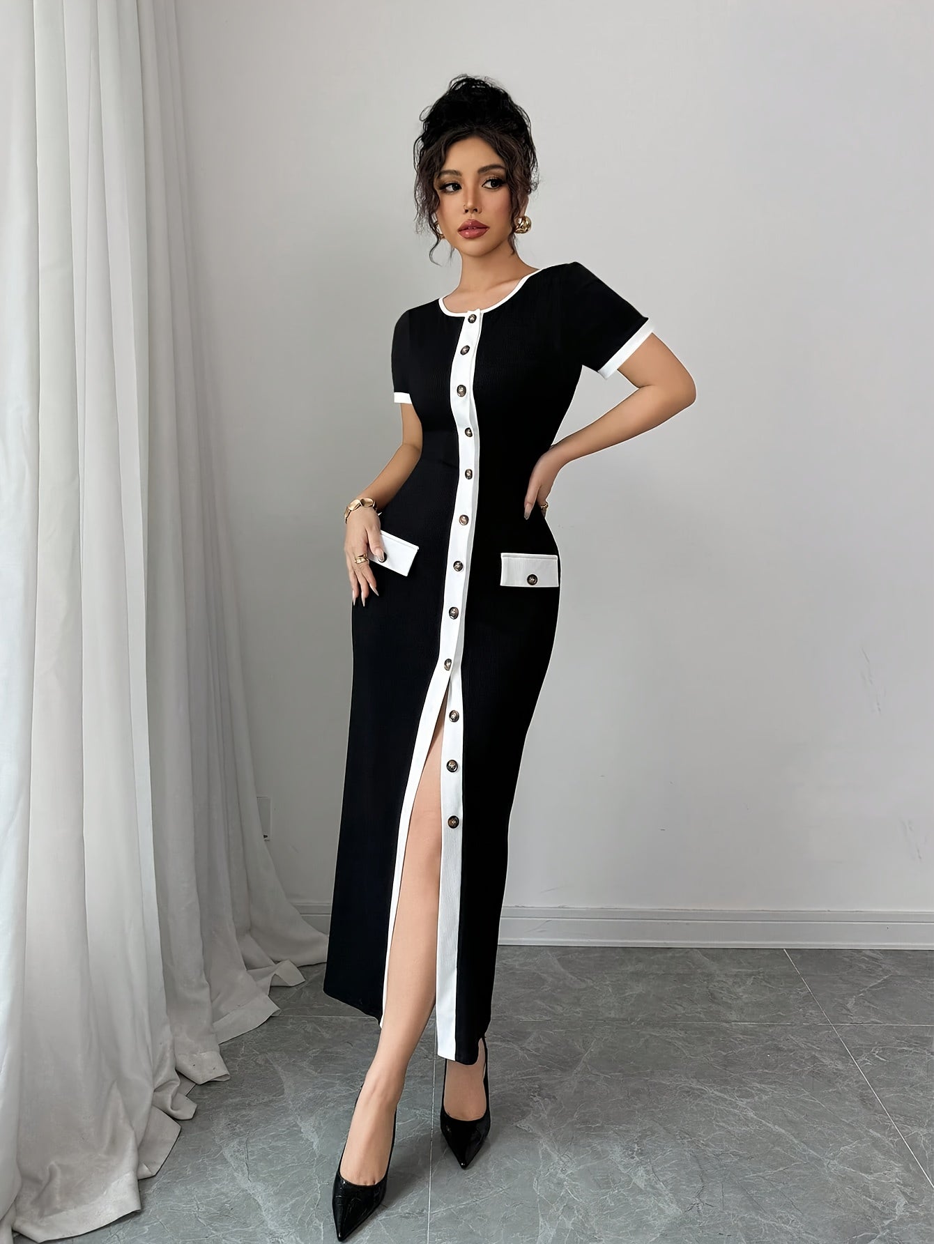 SHOWLU FASHION color block A-line midi dress in black and white with crew neck, displayed on a hanger.