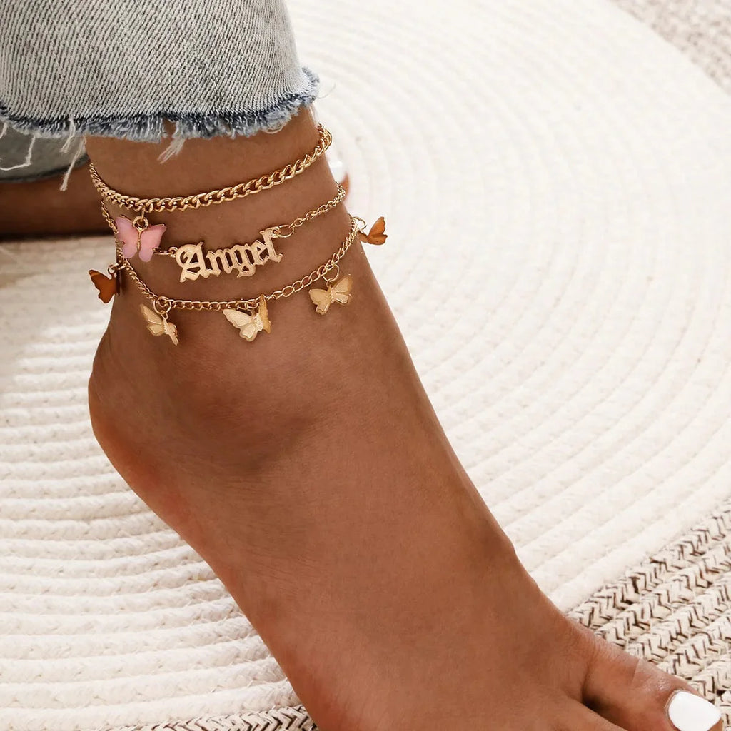 Set of four bohemian shell chain anklets with crystal accents, perfect for summer beachwear and stylish ankle jewelry.