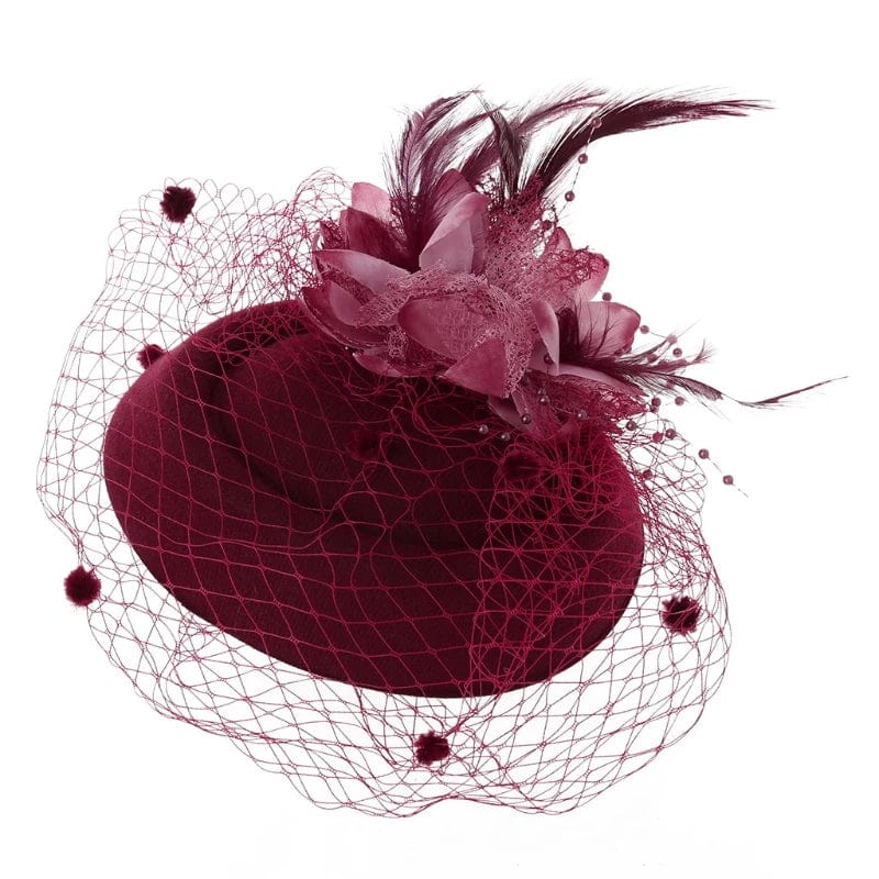 Women's fascinator hat by Showlu Fashion with feather flower design, veil, and pillbox style for elegant events and tea parties.
