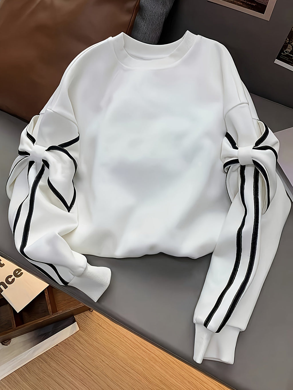 White women's ruffled sleeve sweatshirt by SHOWLU FASHION STORE, casual knit pullover with stylish ruffle details and long sleeves.