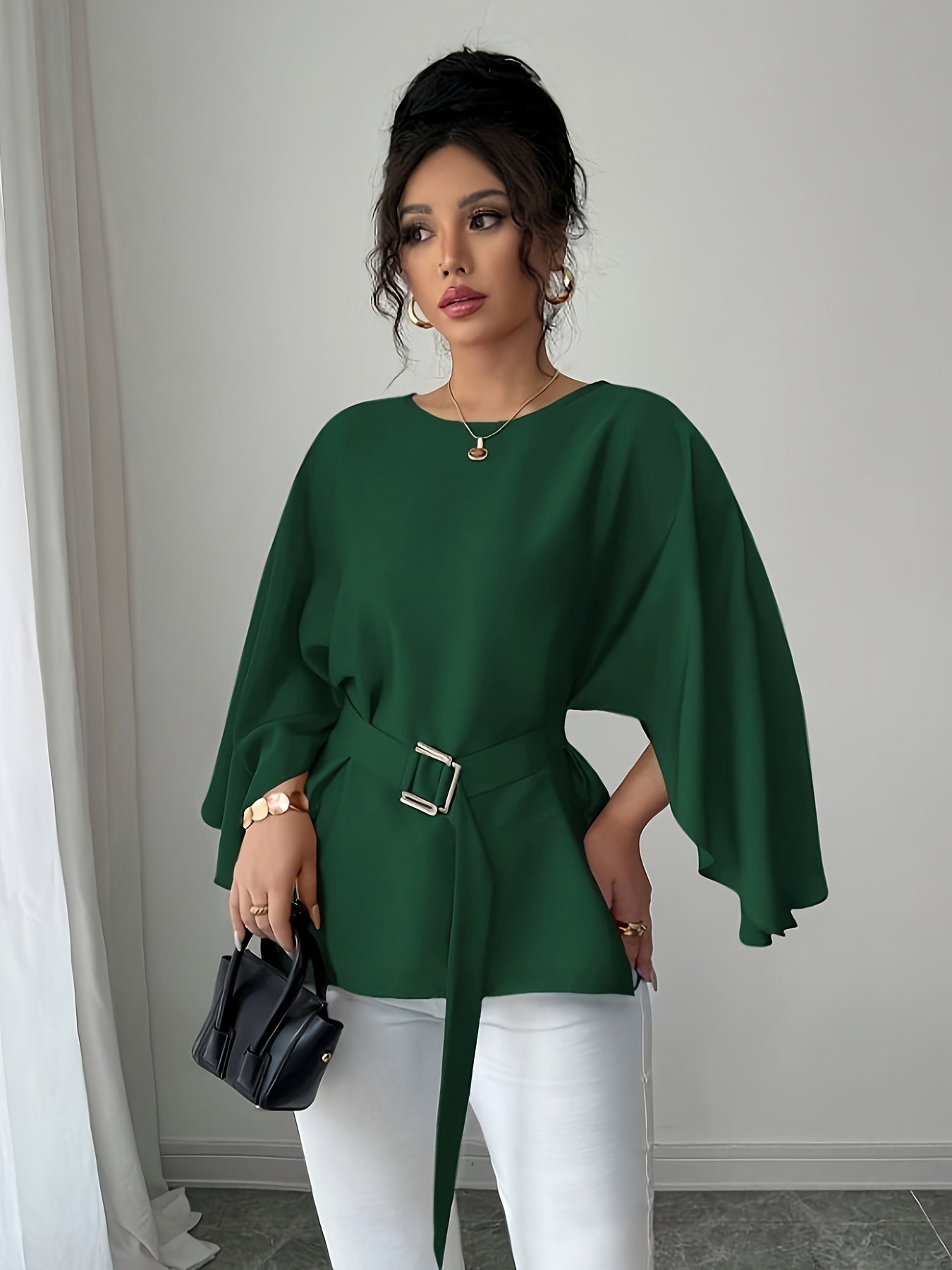 Light blue SHOWLU FASHION long sleeve belted blouse with elegant crew neck, showcased on a hanger.