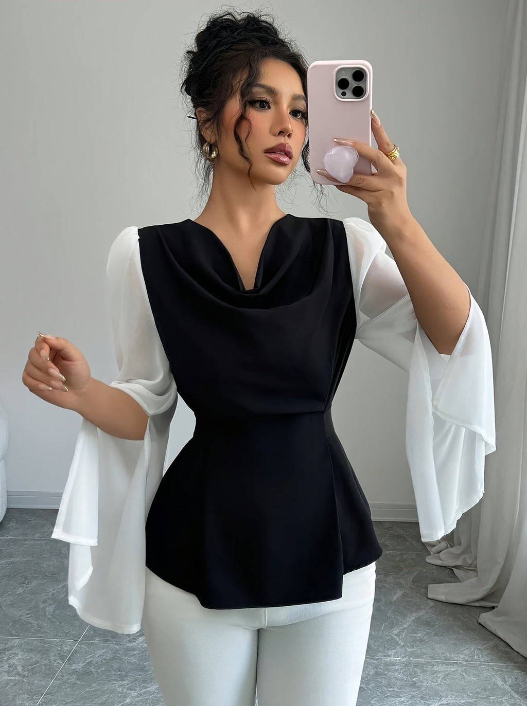 SHOWLU Women's black and white pleated asymmetrical long sleeve blouse with stylish design and flowing fabric.