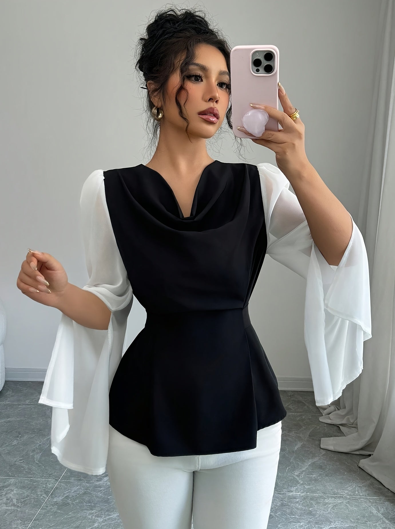 SHOWLU Women's black and white pleated asymmetrical long sleeve blouse with stylish design and flowing fabric.