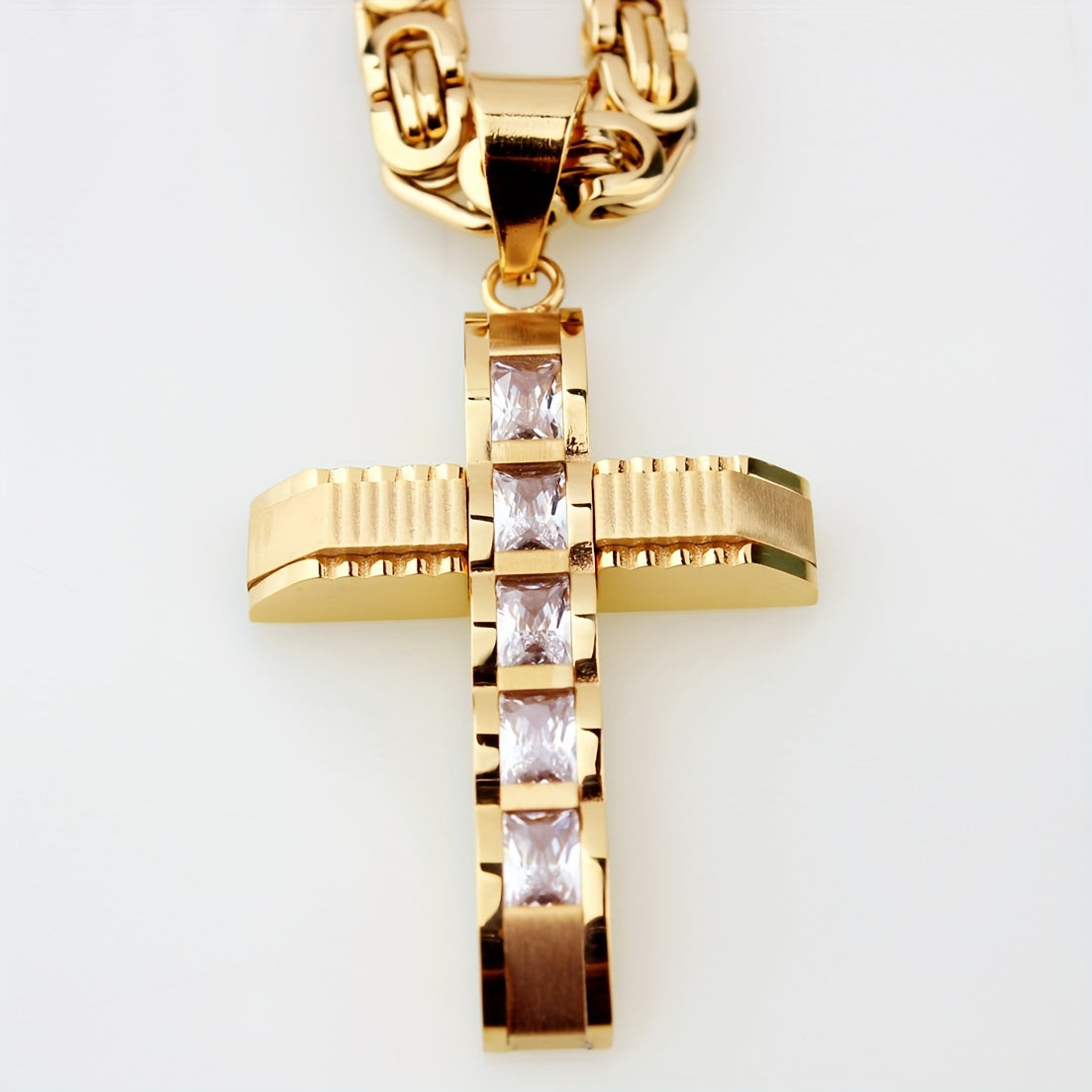 Showlu men's 14K gold plated stainless steel cross pendant necklace hanging on a chain, close-up view of the jewelry piece.