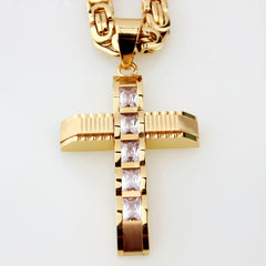 A gold-plated stainless steel cross pendant with rhinestone accents on a matching chain.