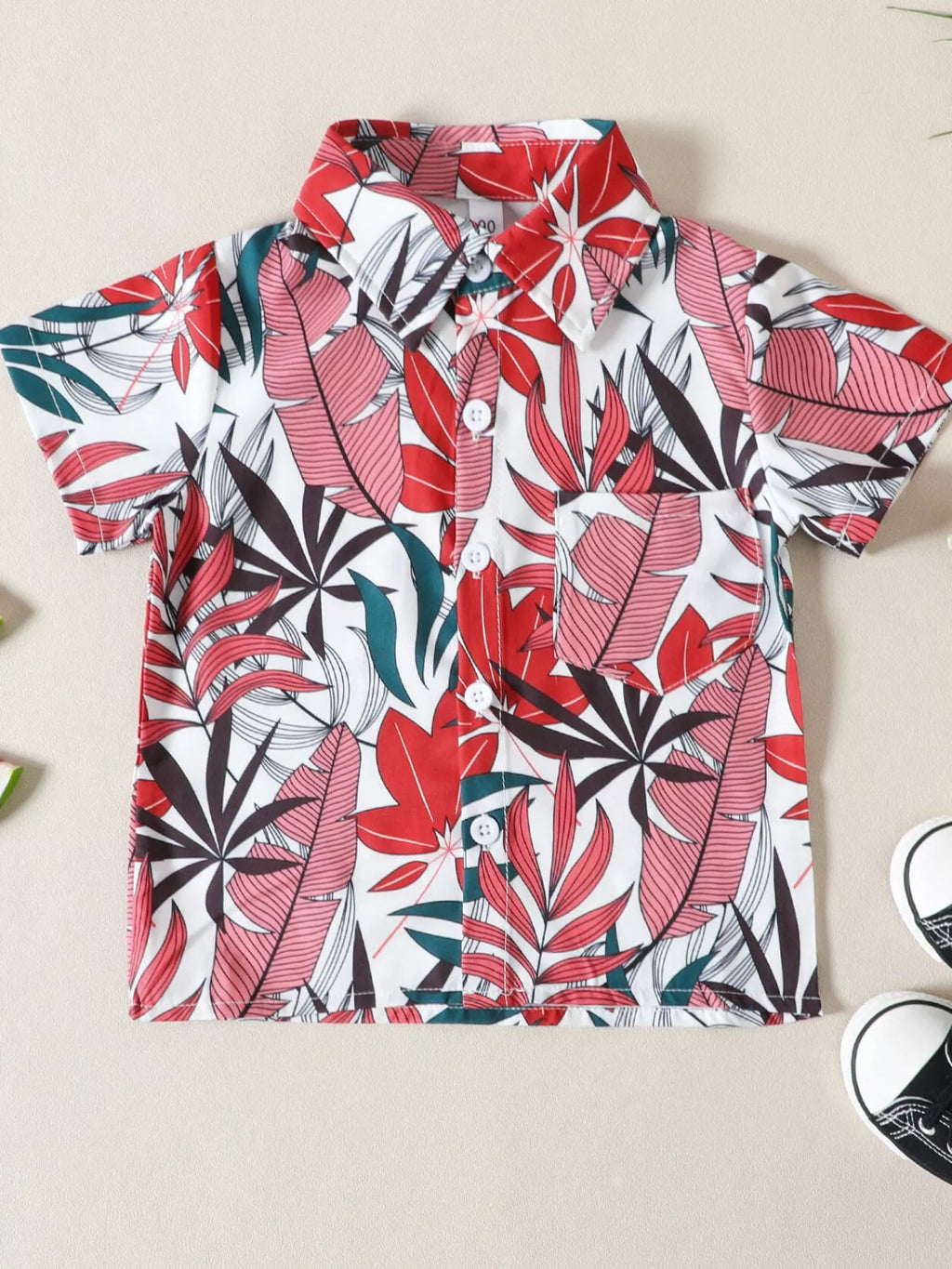 Children's tropical leaf print shirt and shorts set from Trendsi, featuring vibrant green leaf patterns on lightweight fabric.