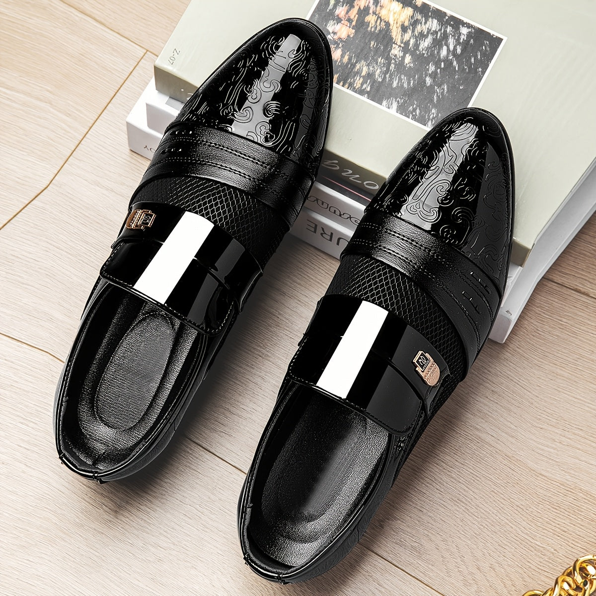 Black embossed slip-on dress shoes for men with pointed toe design, featuring sleek leather style and elegant footwear profile.