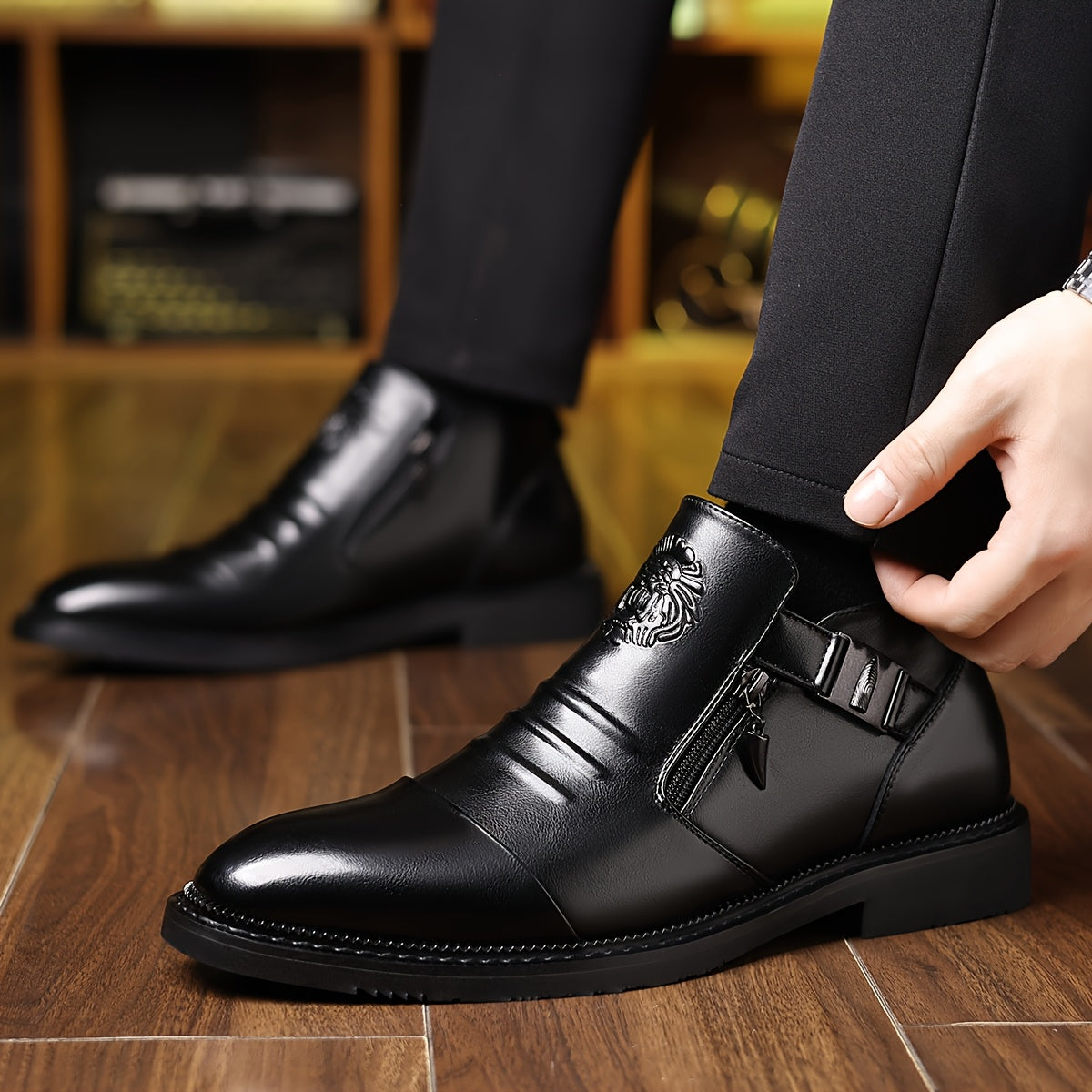 Men's black embossed lion ankle boots in glossy PU leather, featuring detailed lion design on the sides and stylish ankle height.