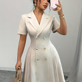 Light beige SHOWLU Women's V-Neck A-Line Dress with asymmetrical hem, elegant and flowy for casual or dressy occasions.