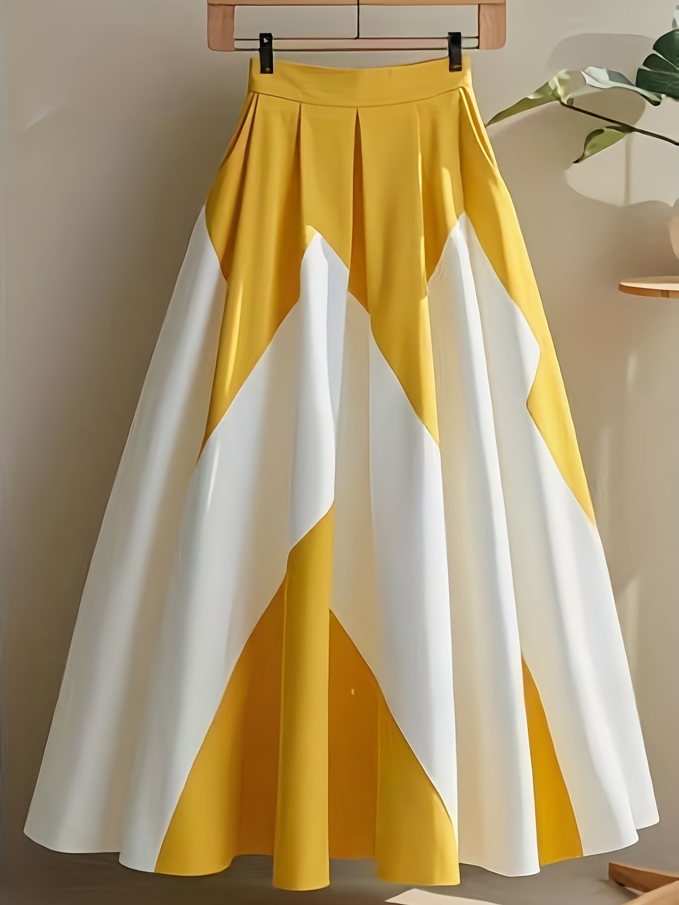 Yellow and white striped high-waist A-line skirt by SHOWLU FASHION, made of polyester, displayed on a hanger.