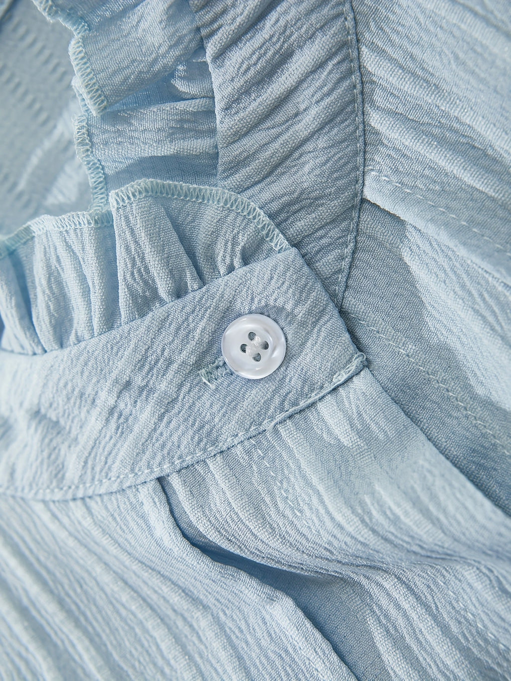 Elegant semi-sheer women's ruffle blouse with puffed sleeves by SHOWLU FASHION, showcasing its delicate fabric and stylish design.