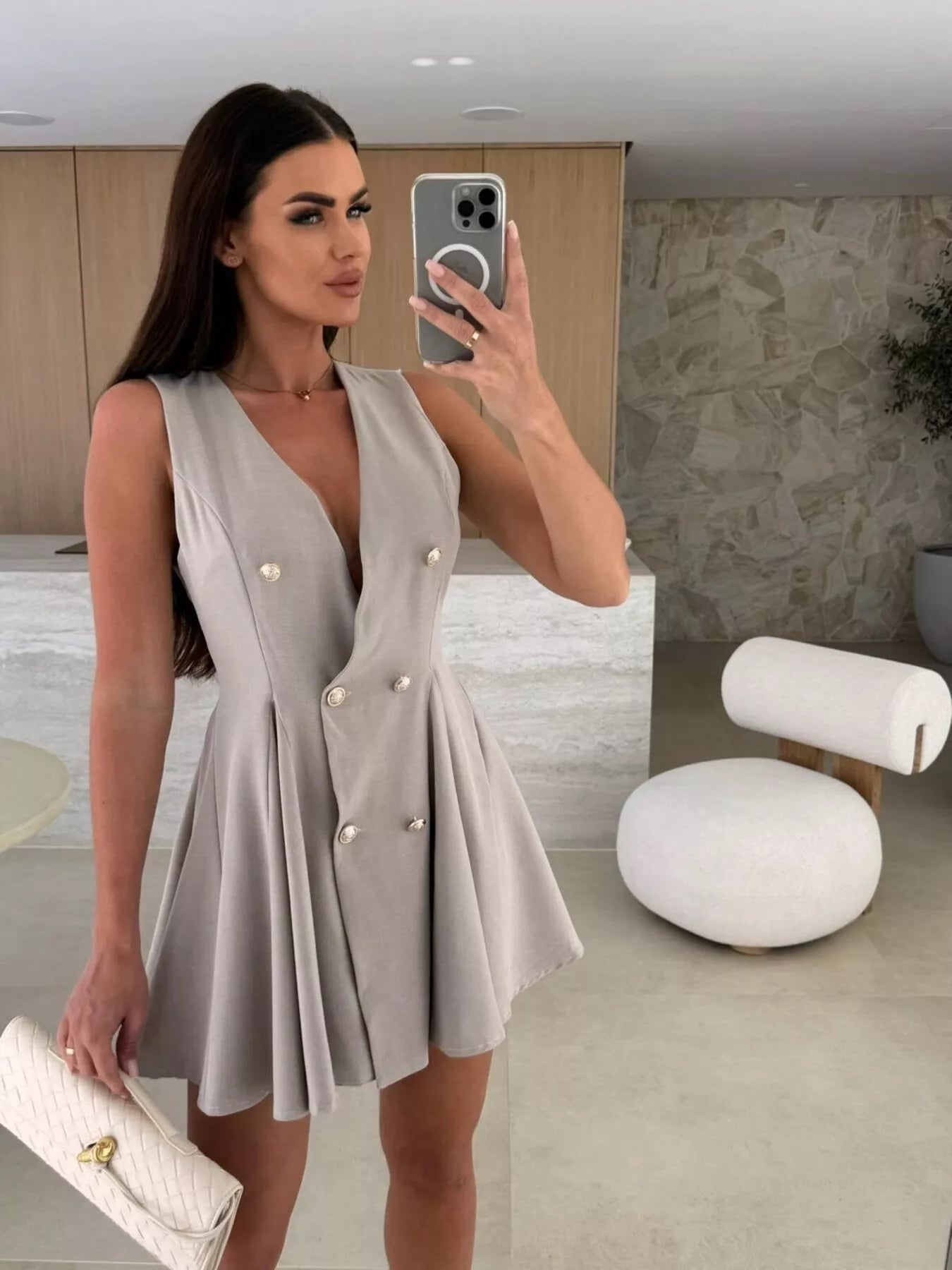 Double-breasted V-neck mini dress by Trendsi featuring long sleeves and a fitted silhouette, displayed on a hanger.