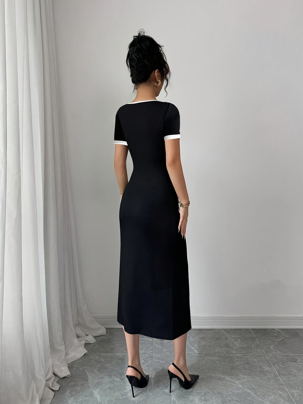 SHOWLU FASHION color block black and white A-line midi dress with crew neck, displayed on a hanger against a neutral background.
