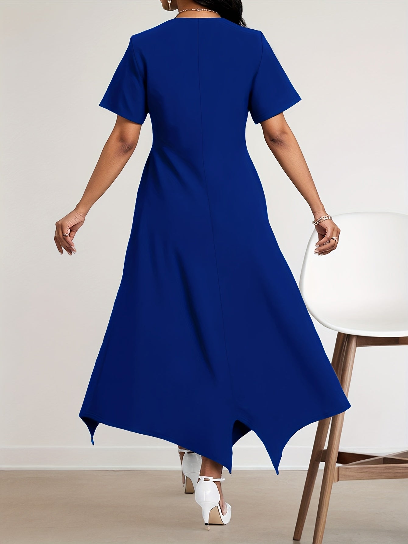 Royal blue SHOWLU FASHION women's asymmetrical hem A-line dress displayed on a hanger with flowing fabric and stylish design details.