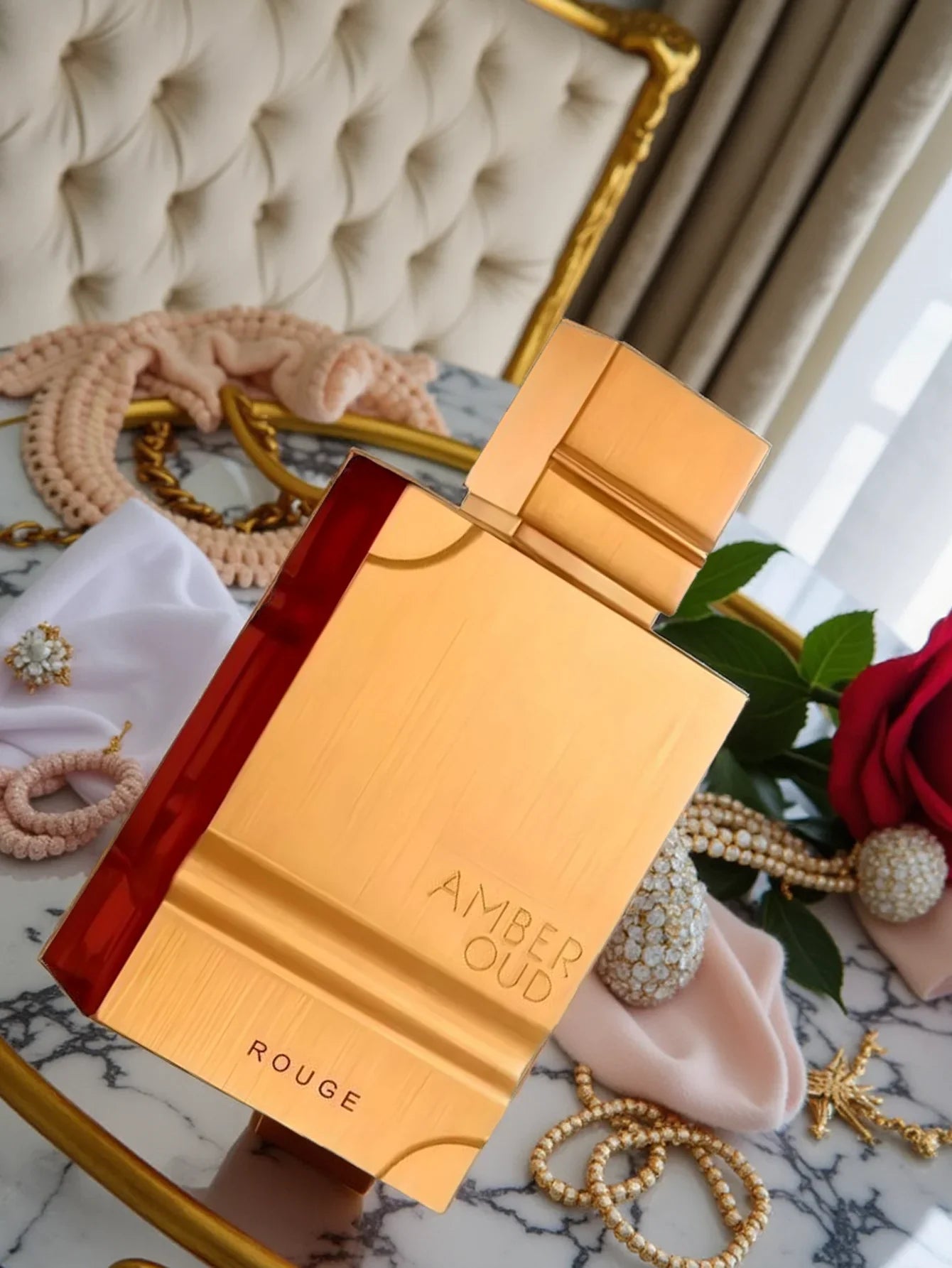 Unisex Al Haramain Amber Oud Rouge Eau de Parfum bottle with floral and amber notes, 60ml, displayed on a neutral background.