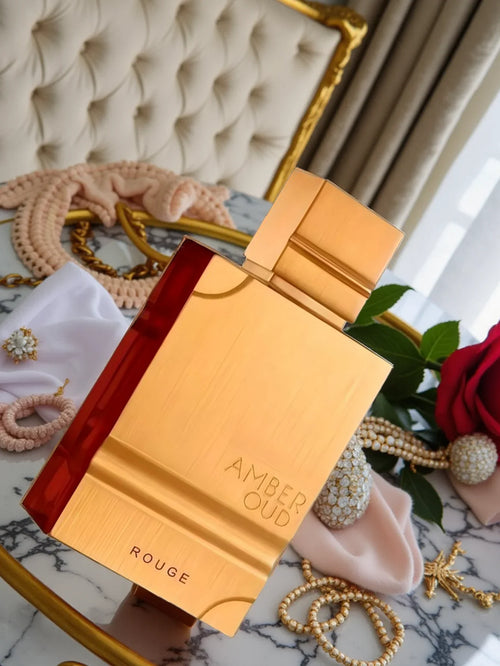 Unisex Al Haramain Amber Oud Rouge Eau de Parfum bottle with floral and amber notes, 60ml, displayed on a neutral background.