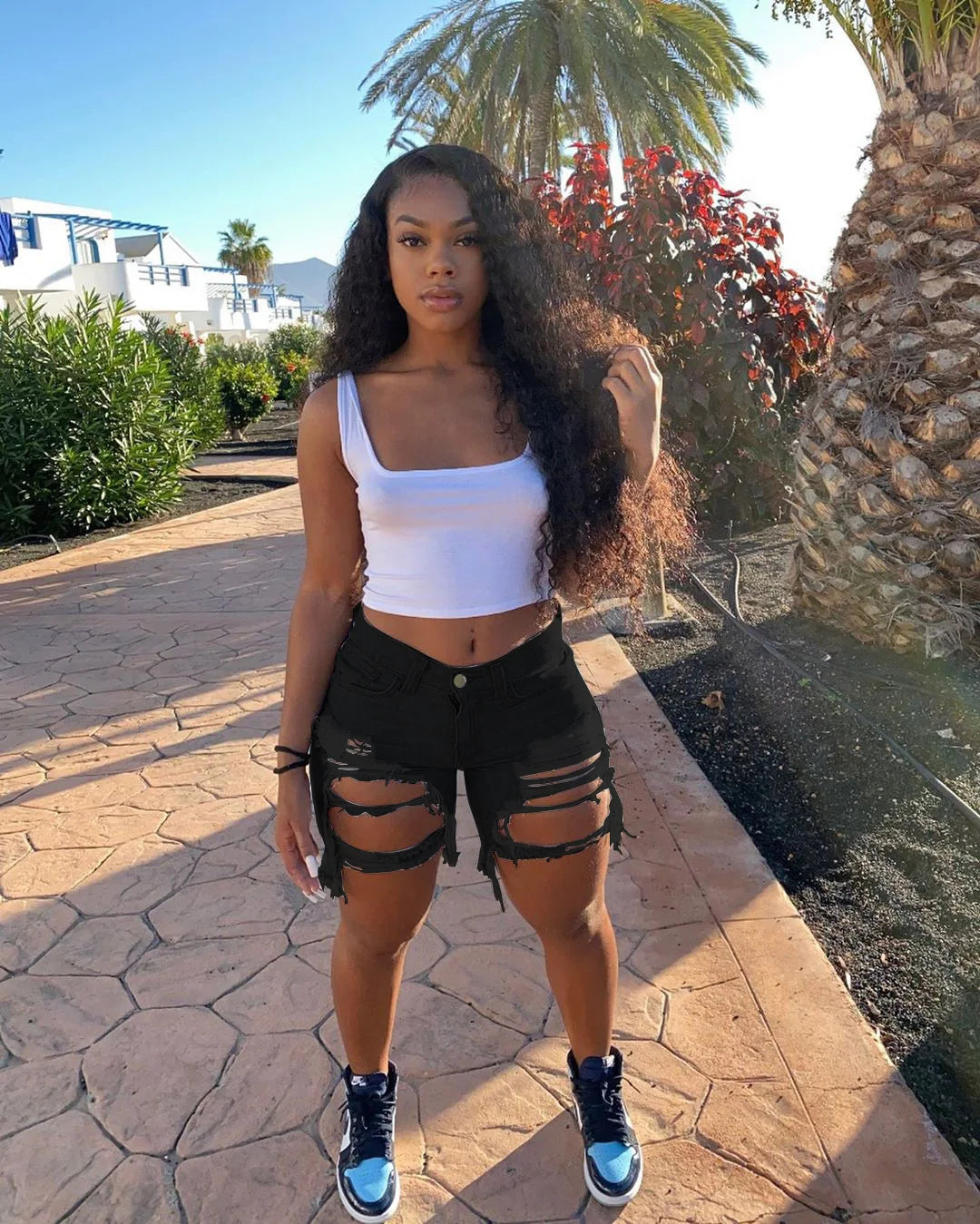 SHOWLU Women's ripped denim shorts with high waist and distressed details, made from cotton jean fabric for a trendy, sexy look.
