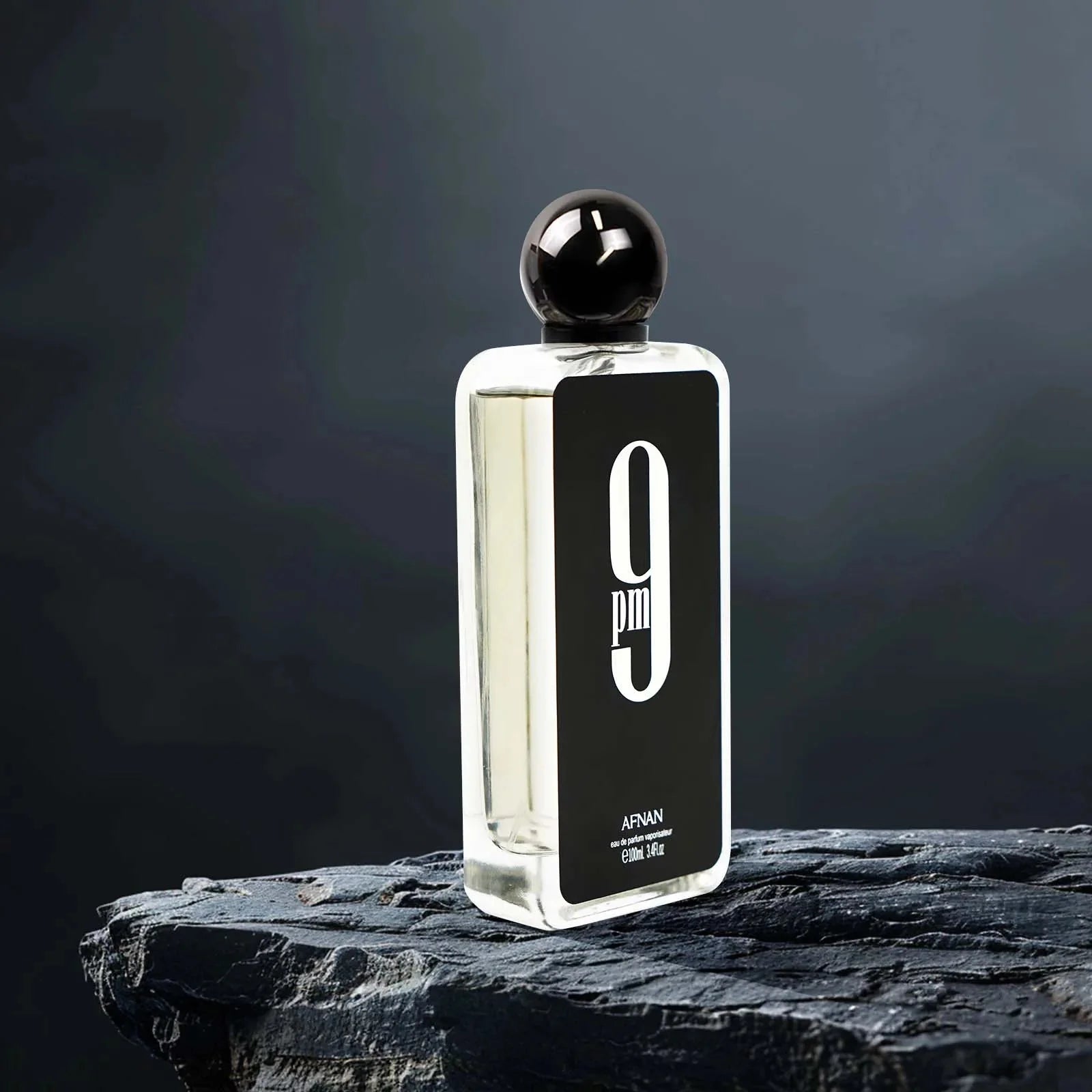 A 3.4 oz bottle of Afnan 9PM men's Eau De Parfum with a sleek design, showcasing its spicy scent and long-lasting fragrance.