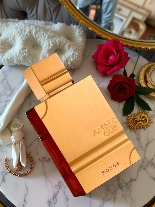 Unisex Al Haramain Amber Oud Rouge Eau de Parfum bottle with floral accents, 60ml, showcasing elegant packaging and fragrance essence.