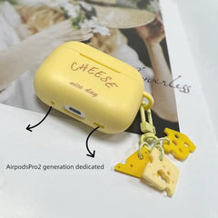 A yellow silicone AirPods Pro 2 case with cheese-themed charms and the text Cheese nice day.