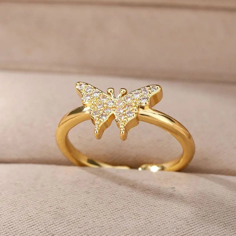 Elegant adjustable stainless steel bee and butterfly ring with cubic zirconia accents, featuring moon and heart designs for women.