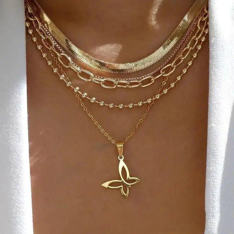 Gold boho multilayer chain necklace with pearl, cross, and heart pendant, featuring an elegant and unique design.