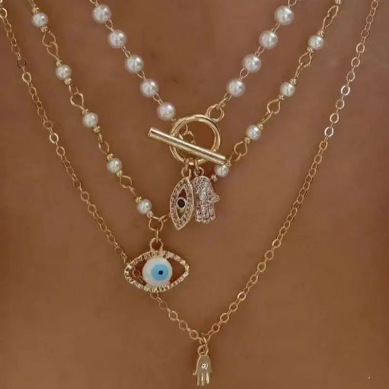Gold boho layered necklace with pearl, cross, and heart pendants, featuring a multilayer chain design from Showlu Fashion Store.
