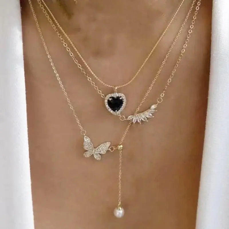 Gold boho multilayer chain necklace with pearl, cross, and heart pendant, stylish and elegant jewelry for women.