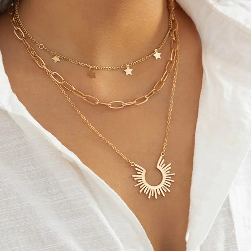 Gold boho multilayer necklace with pearl, cross, and heart pendant, featuring an elegant and unique design for women.