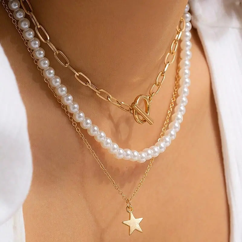 Gold boho multilayer chain necklace with pearl, cross, and heart pendants, elegant jewelry design for women.