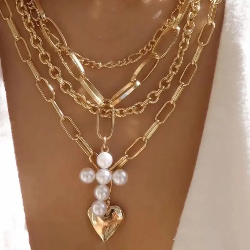 Gold boho multilayer chain necklace with pearl cross and heart pendant, elegant jewelry for women.