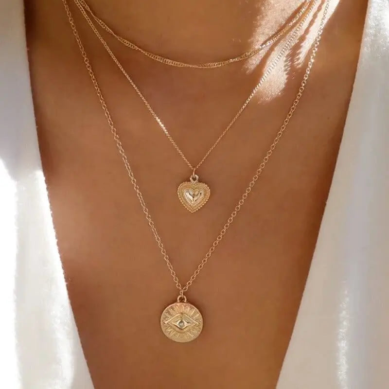 Gold boho multilayer chain necklace with pearl, cross, and heart pendants, elegant jewelry piece for women