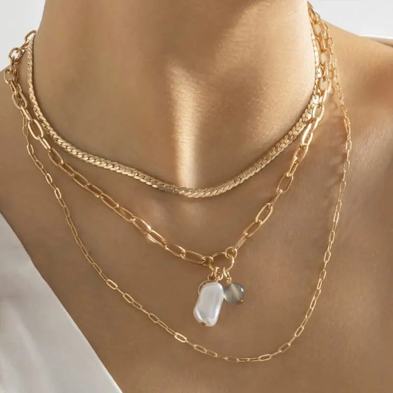 Gold boho layered pearl cross heart pendant necklace with multilayer chain, elegant jewelry for women.