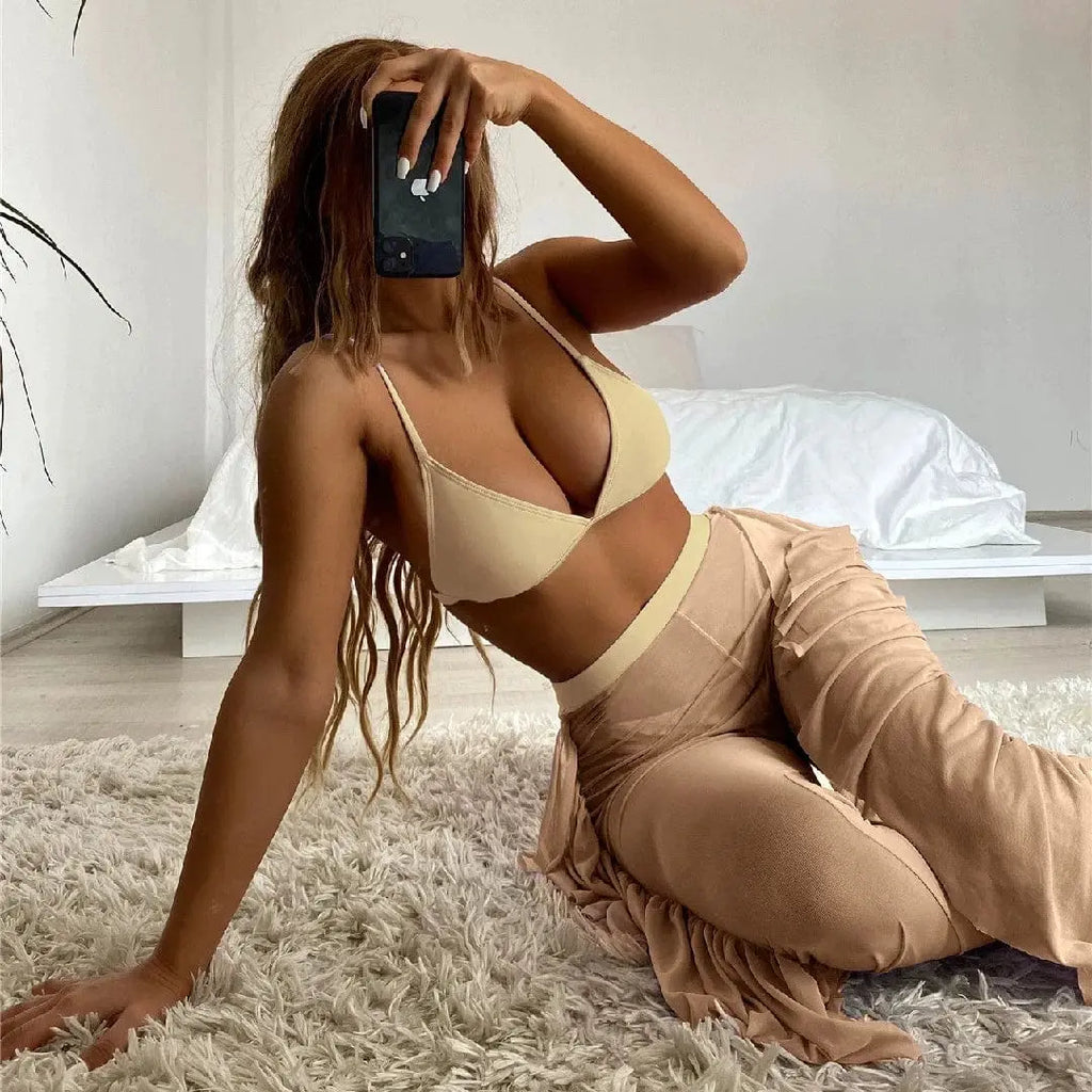 Showlu Fashion three-piece frill bikini set with see-through trousers, stylish swimwear for beach or poolside lounging.