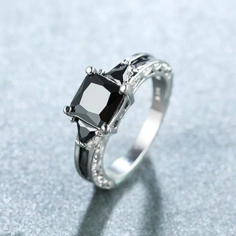 Elegant black zircon princess cut wedding ring for women in silver color, featuring inlaid black stones and a delicate design.