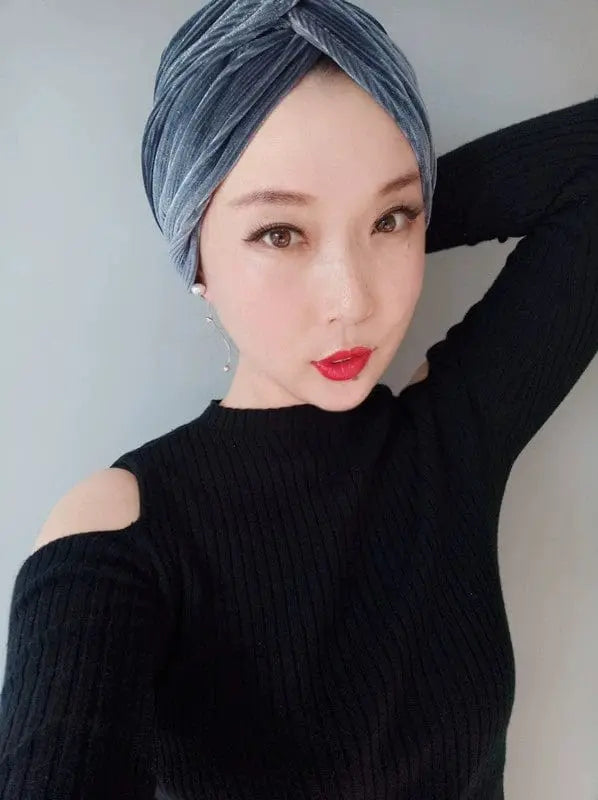 Gray velvet MiuMiu elastic dome-style beanie for women, showcasing soft fabric and snug fit in a close-up image.